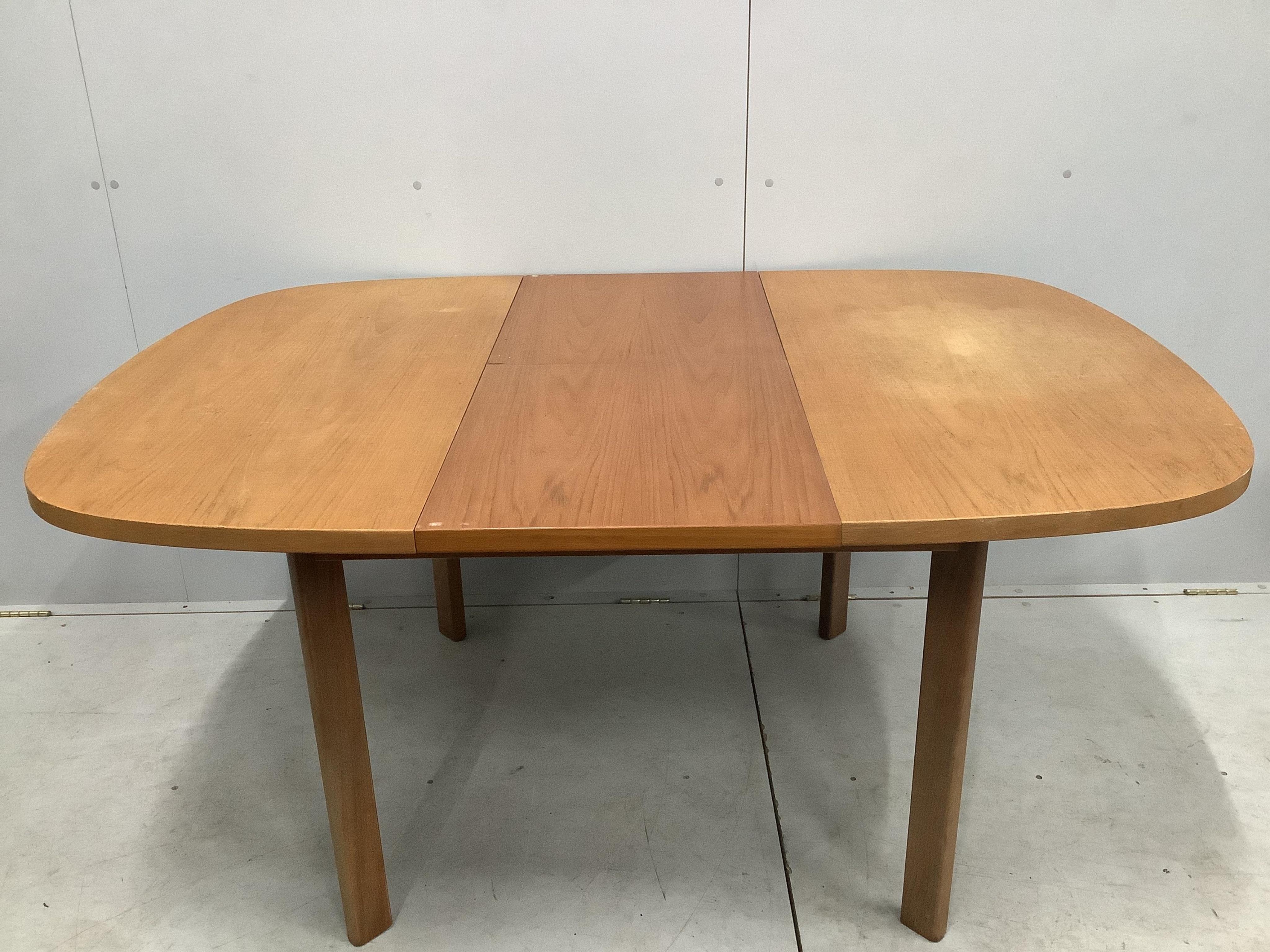 A mid century G Plan teak extending dining table, 158cm extended, depth 112cm, height 72cm and four chairs. Condition - fair to good